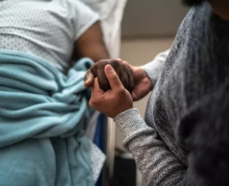 family member holding hand