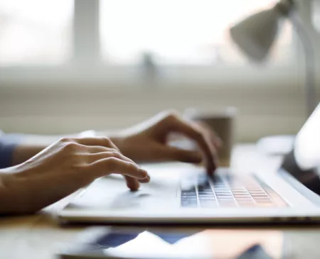 person typing on laptop