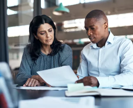 two coworkers looking at paperwork