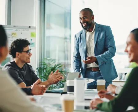 Man presenting at office meeting with team
